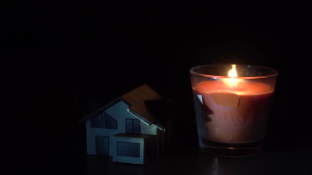 Eine Kerze Und Ein Spielzeughaus Auf Dunklem Hintergrund — Stockvideo