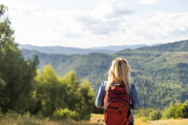 young woman hiking in Carpathian Mountains.