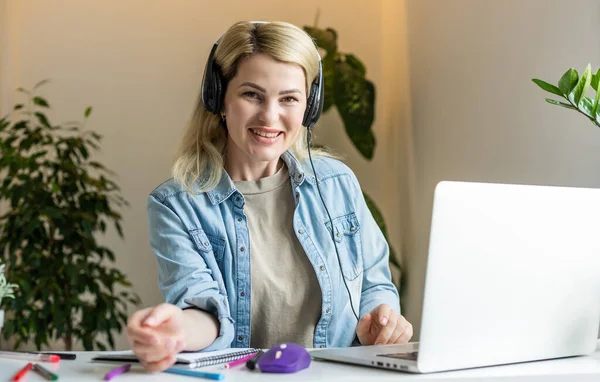 stock image Pretty female student with cute smile keyboarding something on net-book while relaxing after lectures in University, beautiful happy woman working on laptop computer.