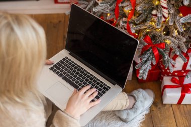 İnternetten Noel hediyesi sipariş eden genç bir kadın..