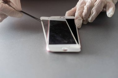 Kiev, Ukrayna - 10 Aralık 2022: Yakın çekim iPhone onarımı, koruyucu camların değiştirilmesi.