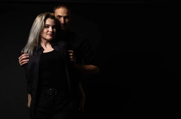 portrait of fashion couple on black background.