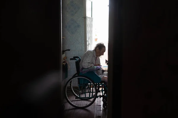 very old woman in a wheelchair.
