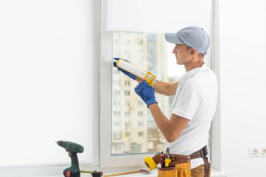 Yüksek lisans çalışmaları. Genç tamirci ayarı yeni windows appartment, yakın çekim.