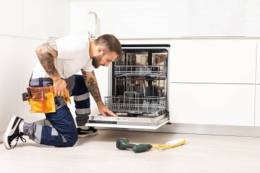 Craftsman repairs broken dishwasher.