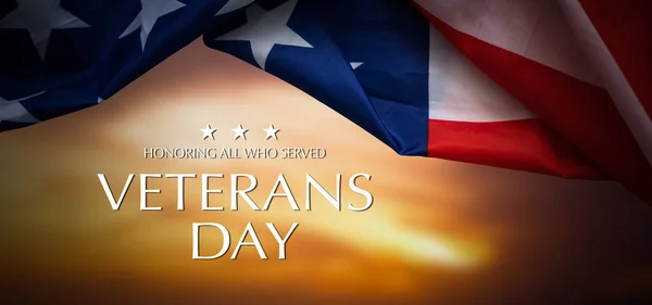 American flags with Text Veterans Day Honoring All Who Served on background. American holiday banner. High quality photo