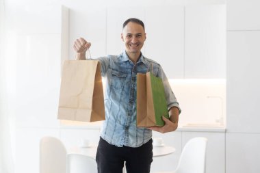 Middle age handsome man holding package.