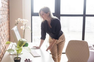 a woman with a computer working from home.