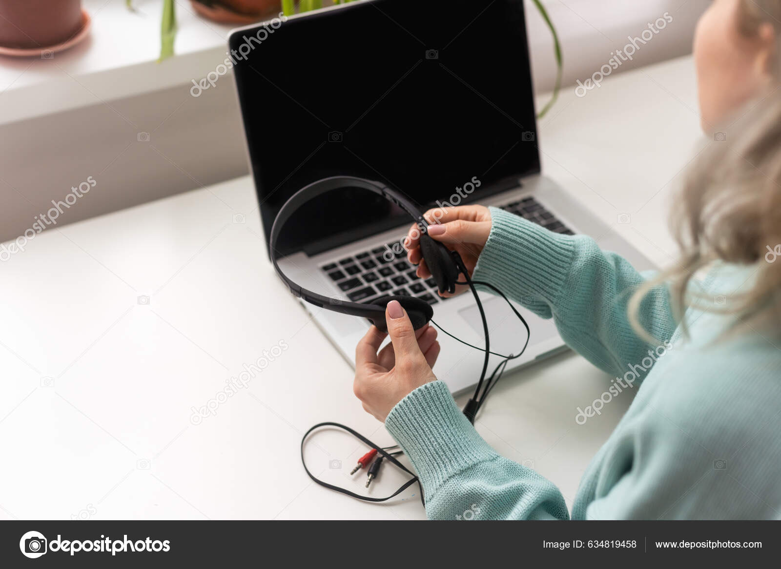mixed race young woman typing on computer keyboard at table with