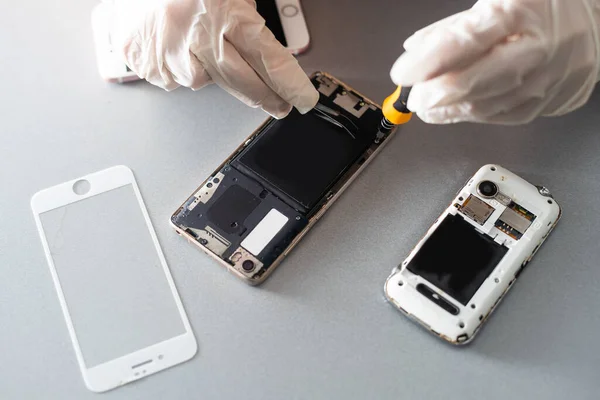 Close-up photos showing process of mobile phone repair.