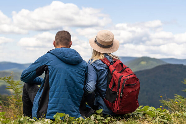 Couple travelers Man and Woman sitting relaxing mountains, view Love and Travel happy emotions Lifestyle concept. Young family traveling active adventure vacations.
