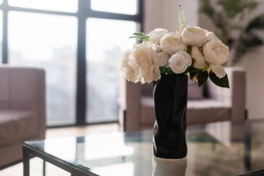 green plants in ceramic vase in living room on table.