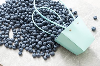 large blueberries in a green market basket.