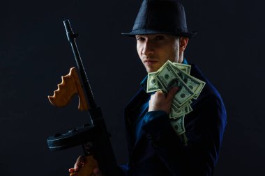 Mature man in sunglasses with gun.