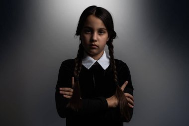 Halloween. A girl in a suit. Holiday. Hallowmas. Wednesday Cosplay. Idea for Halloween. Portrait of a girl