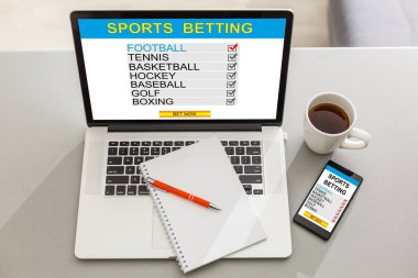 Sports betting concept on laptop, tablet and smartphone screen over gray table clipart