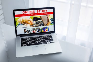 Laptop on a sofa against a window