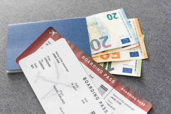 Two blue passports, green boarding pass, flight tickets background close up top view, airplane travel, passengers check in, customs control, border cross, holidays, vacation, tourism