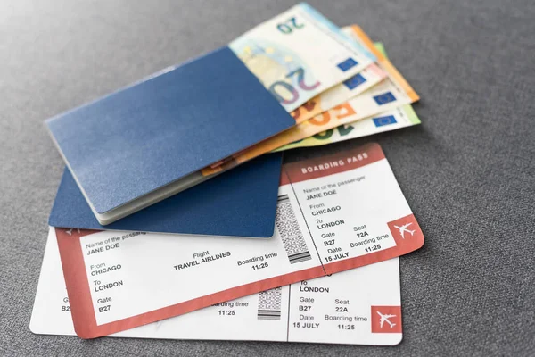 Two blue passports, green boarding pass, flight tickets background close up top view, airplane travel, passengers check in, customs control, border cross, holidays, vacation, tourism