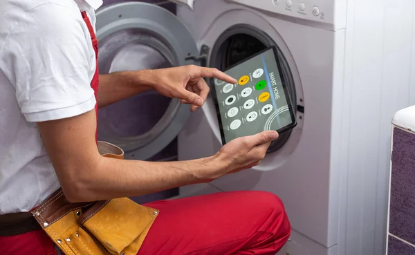 Serviceman Repairing Washing Machine Looking Tablet — Stock Photo, Image