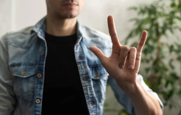 Man showing gesture in sign language on white background.