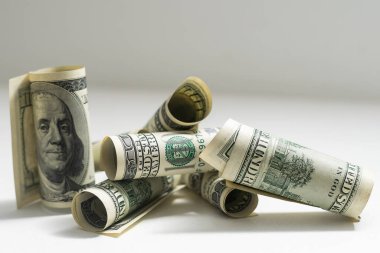Belted roles of dollars closeup.