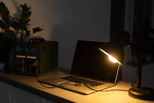 Portable power station charging gadgets on table in room