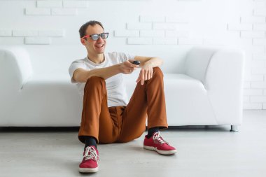 Mature Man On Couch Watching Television
