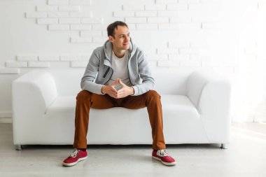 A young man of European appearance at home. Remote work, quarantine during an epidemic of coronavirus COVID-19