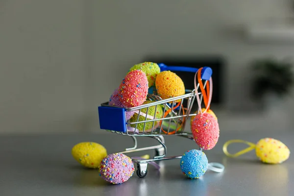 shopping cart with easter eggs for hunting or give away