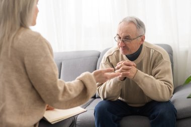 Caregiver psychologist console american senior people for mental health, geriatric psychology, Depressed senior man talking with female psychologist, desperate people, emotions sad, elderly worry,