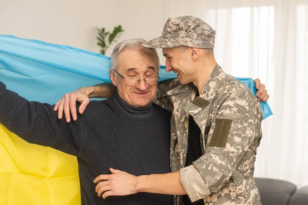 elderly father and son military flag of Ukraine.