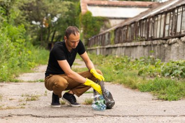 A young man, a nature conservationist, walks to collect trash in the mangrove forest.