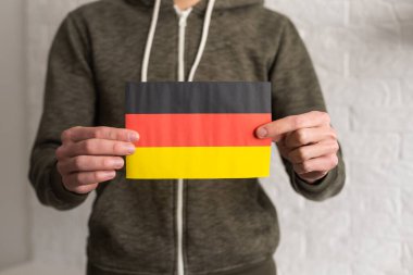 German flag in hands. Modern education, language learning and knowledge exchange