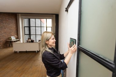 Female hands holding digital tablet with smart home app.