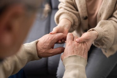 Two people holding hand together. elderly man and support woman.