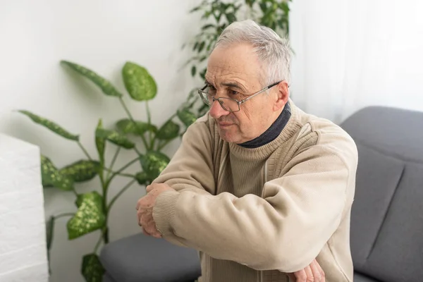 stock image an elderly mans arm hurts.