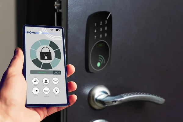 Locking smartlock on the entrance door using a smart phone remotely. Concept of using smart electronic locks with keyless access.