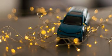 Miniature Car on colorful bokeh background. Holiday Merry Christmas concept