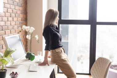 a woman with a computer working from home.