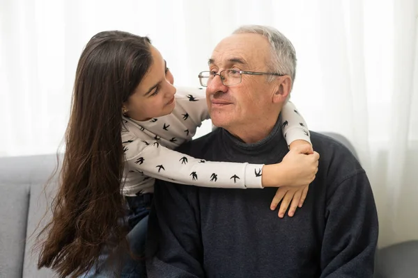 Little Granddaughter Hugging Her Grandfather — Stock Photo, Image