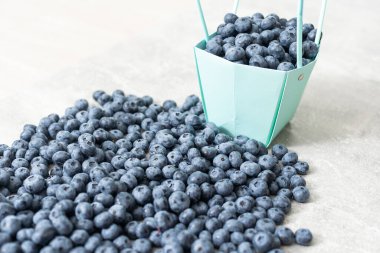 large blueberries in a green market basket.