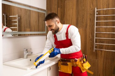 a worker installs a wash basin in a bathroom