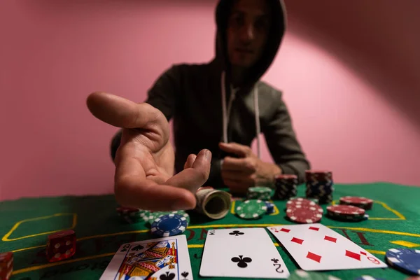 A man sitting at the game table. Male player. Passion, cards, chips, dice, gambling, casino - it is as male entertainment