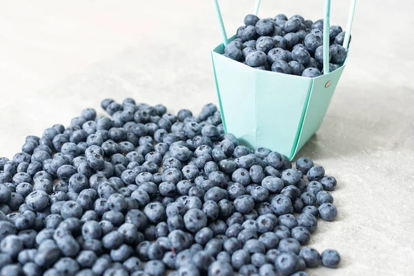 large blueberries in a green market basket.