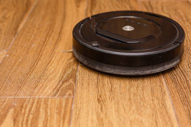 Robot vacuum cleaner, robot vacuum cleaner wipes floors, power button is on and ready to work.