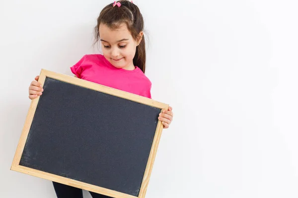 Smiling Little School Girl Holding Blank Chalk Board Copy Space — Stock Fotó