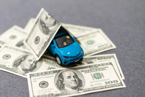 flat lay toy car, toy house, keys and money on the table. High quality photo