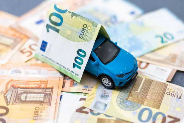 Toy car and euro on white. High quality photo