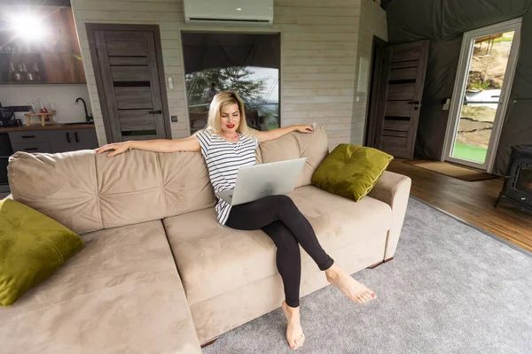 stock image happy middle aged woman using her laptop.